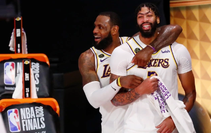 LeBron James and Anthony Davis celebrate championship win against James' old Miami Heat team.
