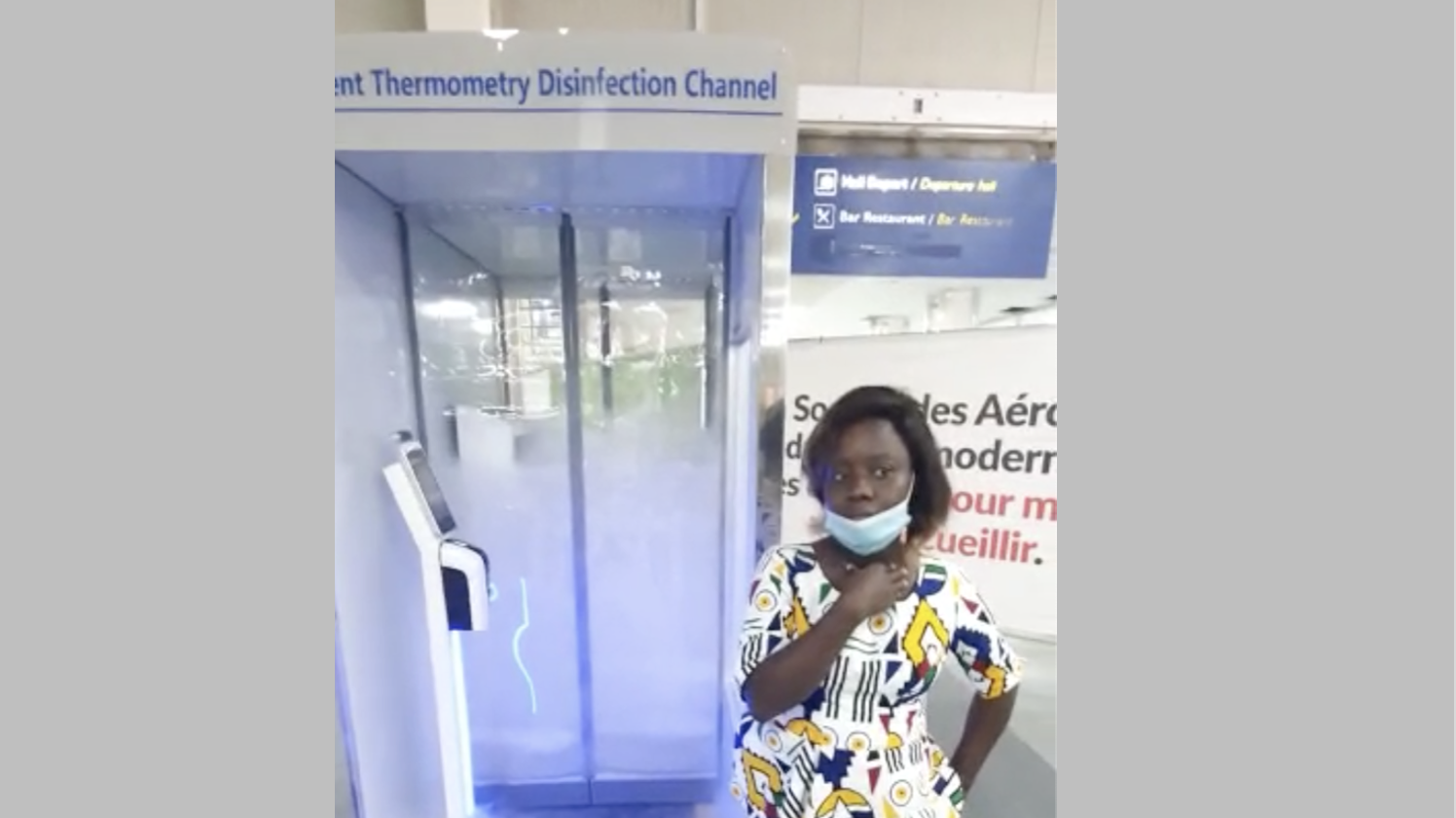 Woman at airport sanitizer booth in Benin