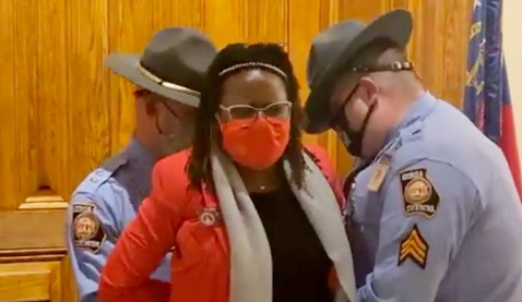 Georgia State Rep. Park Cannon (shown above) is arrested outside door while Republican Governor Brian Kemp was inside signing vo