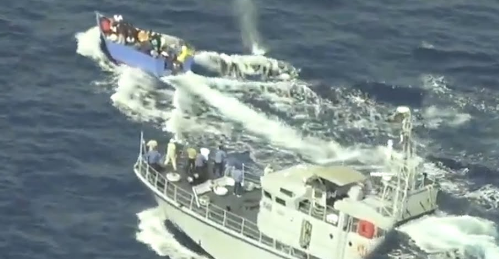 video showing a Libyan coast guard vessel firing at and chasing a boat in distress that was carrying migrants