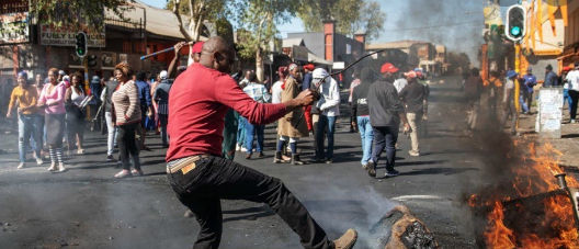 South Africa was gripped by a frenzy of looting and arson - the worst scenes of violence since the advent of democracy in 1994