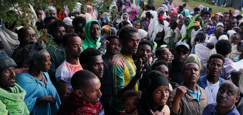 Internally Displaced Persons (IDPs) wait to receive food aid being distributed by the Amhara Emergency Fund