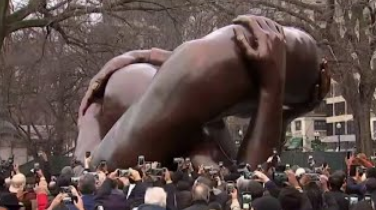 The 22-foot-tall bronze sculpture anchoring the memorial, “The Embrace”